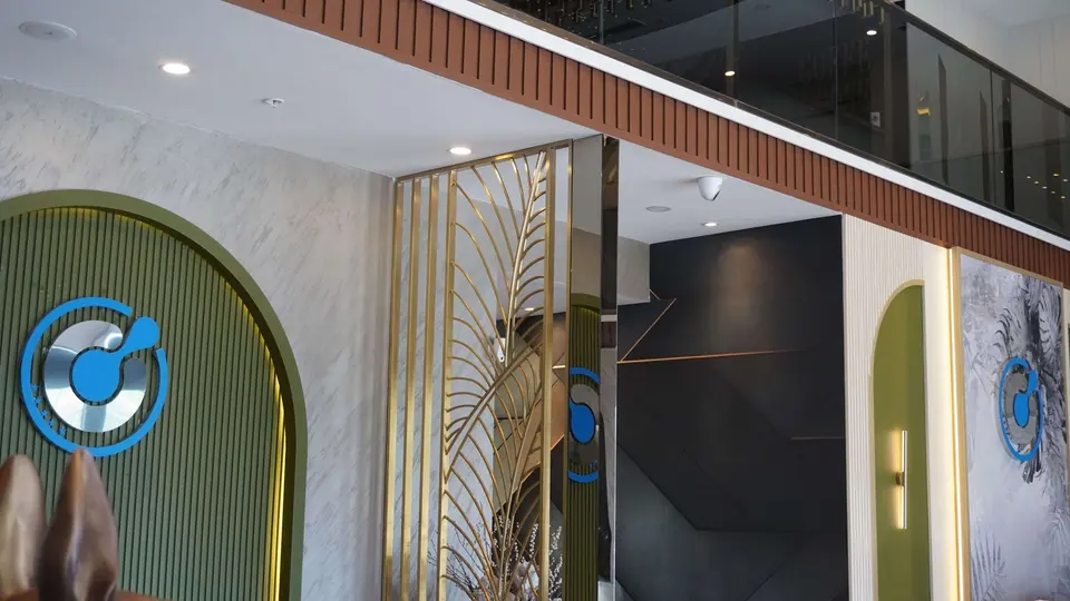 Reception area of BlueMagic Group Clinic with the group emblem and gold screen