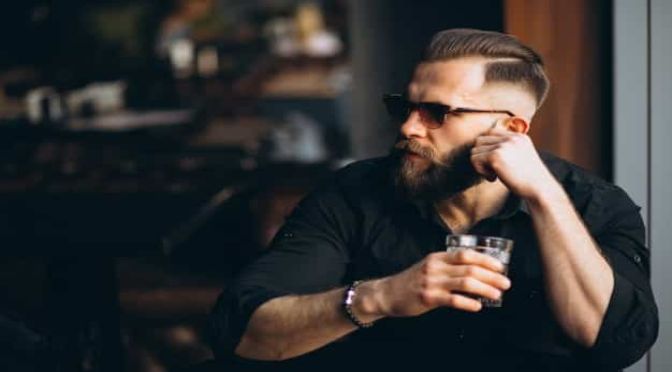 bearded man drinking bar