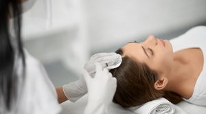 Clinical hair restoration treatment being performed by a medical professional at BlueMagic Group Ltd.